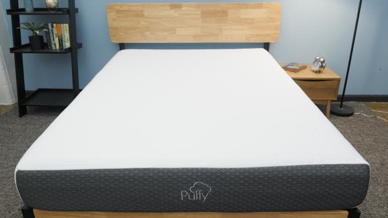 Box with Puffy mattress topper on a mattress